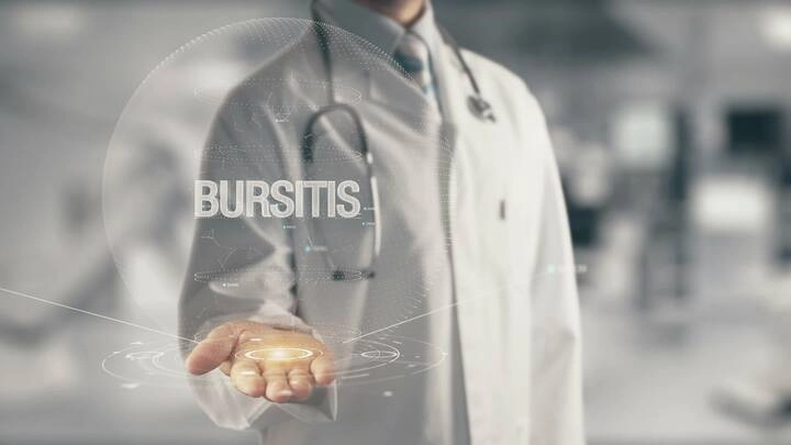 A doctor showing a graphic of the word BURSITIS.