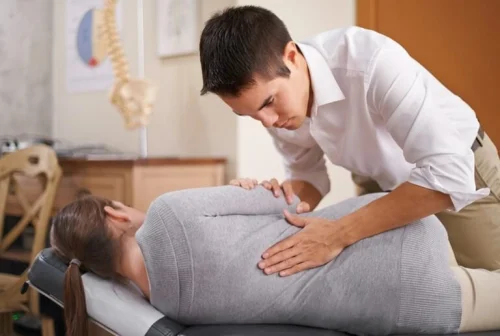 sciatica-treatment-back A young chiropractor treating a woman in her lower back.