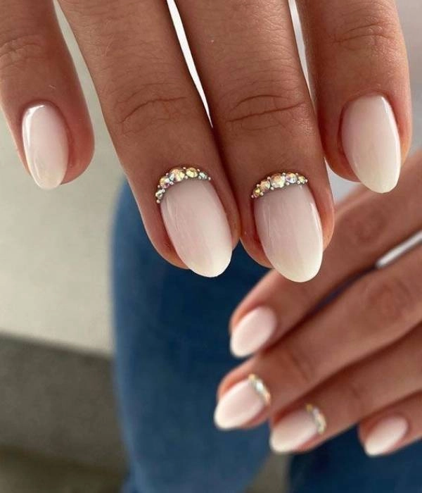 Νυφικά νύχια με στρας και γαλλικό μανικιούρ, σε οβάλ σχήμα, με ένα χρυσό μονόπετρο.