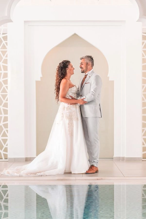 Νύφη και γαμπρός σε κομψό αρχιτεκτονικό χώρο κατά τη φωτογράφιση του γάμου