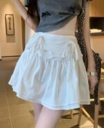 【in a row】Double Ribbon Mini Skirt BLANC-CHIC Double Ribbon Low Mini Skirt | KOODING